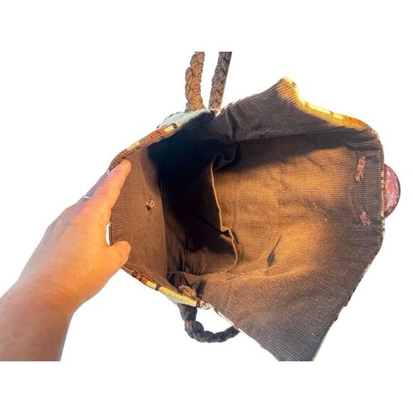 This is a bohemian-style shoulder bag with a braided strap. - Picture 6 of 8